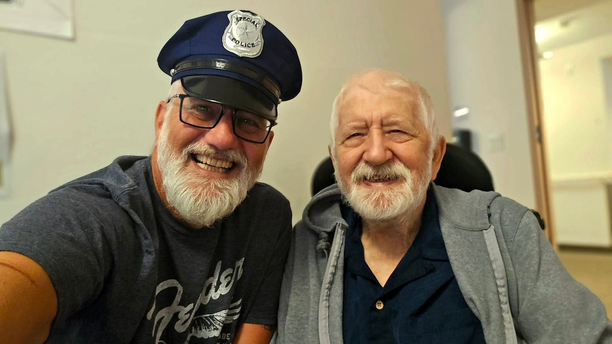 John wearing the Special Police hat beside his father